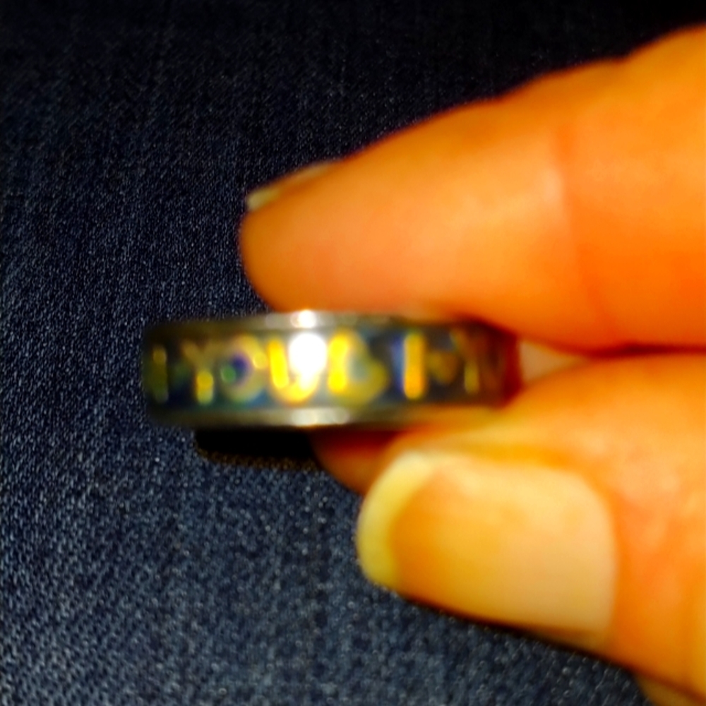 Gold and silver ring says i live you across the band